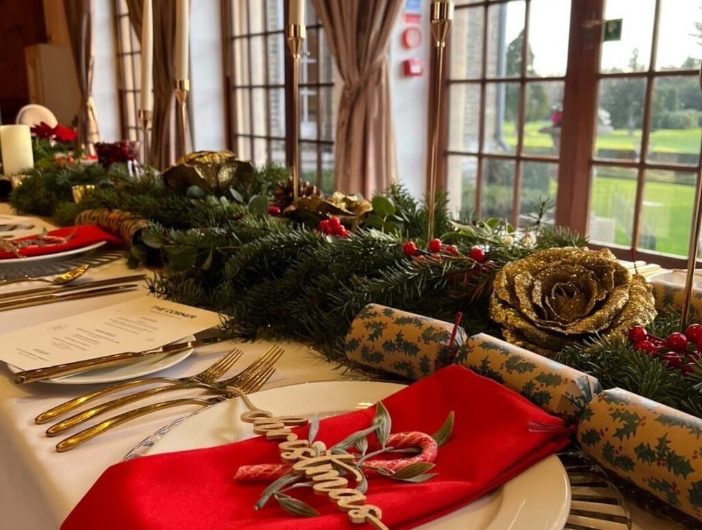 Christmas table setting, red napkins, mistletoe, candy cane & gold christmas wooden word